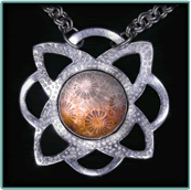 Silver Chased & Pierced Pendant with Translucent Fossil Coral Cabochon.